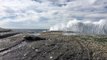 Stunning footage of waves crashing into rocks in slow motion