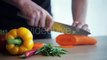 Chefs Hands Chopping Carrot On Wooden Board - Stock Footage | VideoHive 15407808