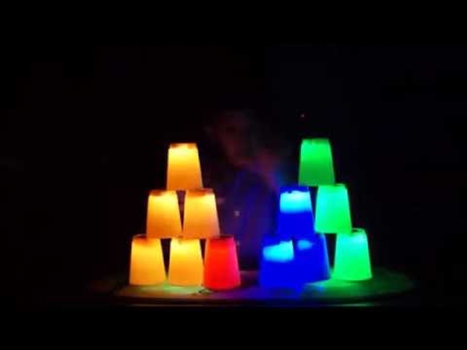 Boy Stacks Glowing Plastic Cups Incredibly Fast