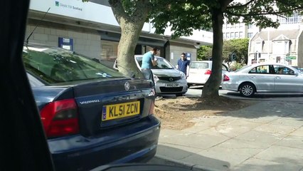 Massive parking fail. Woman tries to reverse out a space the wrong way.Gets help from 2 me