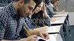 Students Writing with Pens on Paper in a College Classroom during Lecture | Stock Footage -