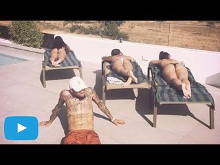 Chris Brown strikes a pose with a bevy of bikini-clad beauties in Ibiza