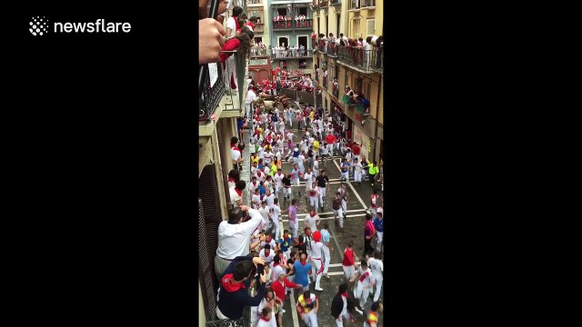Bulls charge down the streets of Pamplona