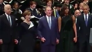 George W. Bush dances during the Dallas Memorial