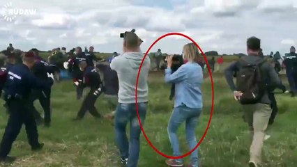 Hungarian camerawoman filming police chase of refugees trips refugee