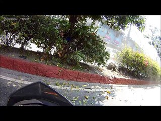 Car Swerves on Center Island Nearly Hitting a Motorcyclist