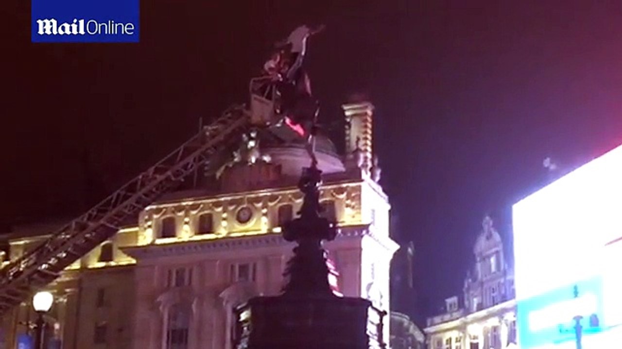 Dare devil climbs 11 metre high Eros statue in Piccadilly