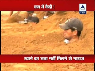 Protesting Bolivian prisoners bury themselves up to their necks