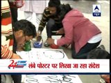 Protesters write their messages on a lengthy white paper at Jantar Mantar