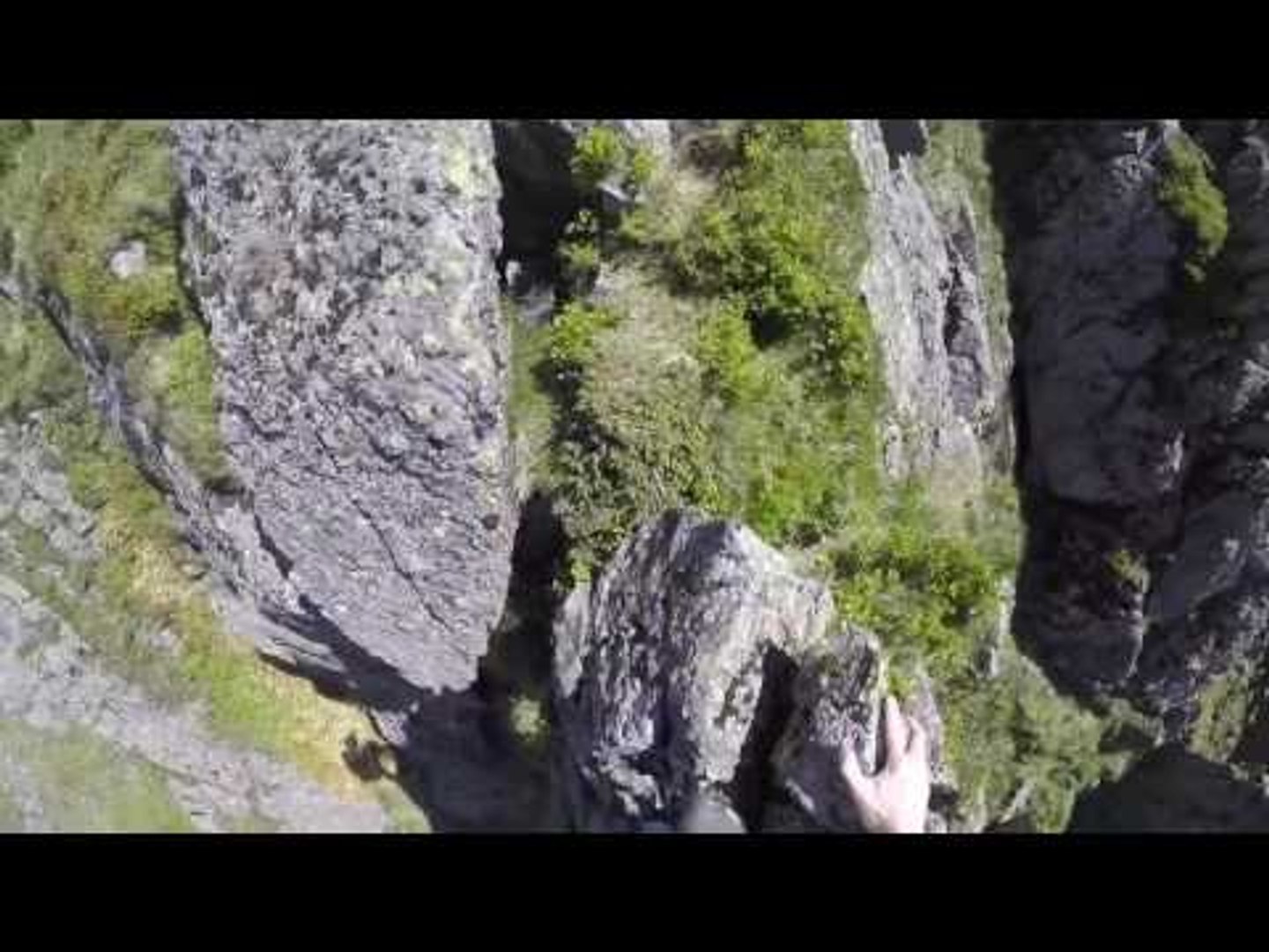 Mountain Runner Free Climbs Narrow Rocky Outcrop