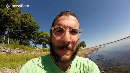 Man uses drone to catch a large fish in a lake