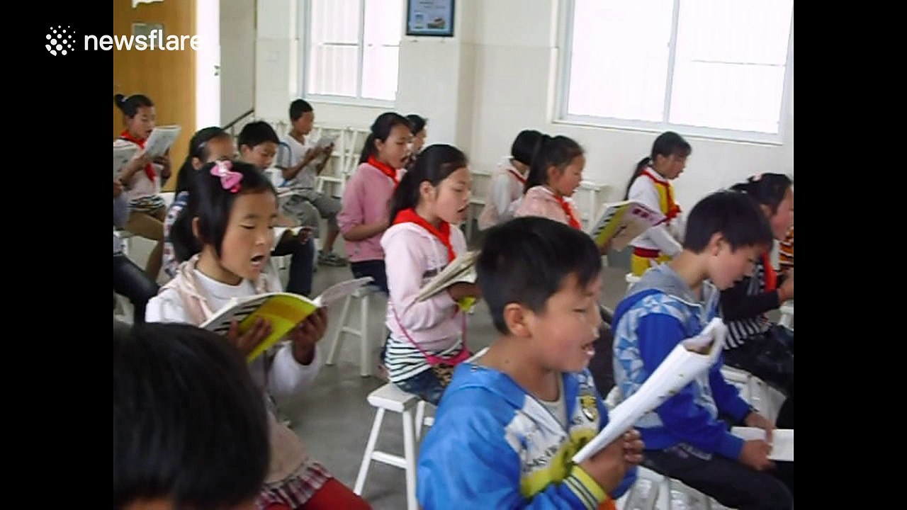 Teacher plays multiple instruments simultaneously to his class