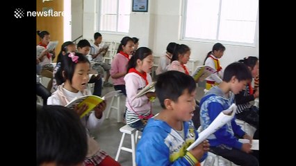 Teacher plays multiple instruments simultaneously to his class