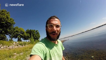 Man uses drone to catch a large fish in a lake (long version)