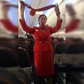 Football fans on flight distracting the air hostess doing the safety announcement