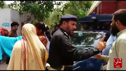 A Women Put Oil on her self in front of Police Station