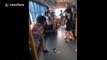 Woman pulls off man's shorts as she falls on bus
