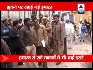 Under construction building tilts toward road