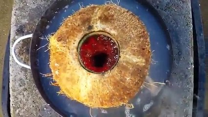 Pouring molten copper into fresh coconut and voyeuristic reaction