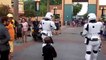 Un enfant déguisé en Kylo Ren escorté par deux stormtroopers