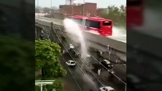 Metro bus giving early morning showers to people going to office on bikes