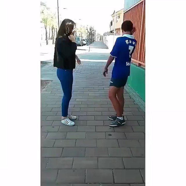 football dribbling betwen a girl and guy finished by kissing each other