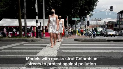 Models with masks walk in demo against air pollution in Medellin