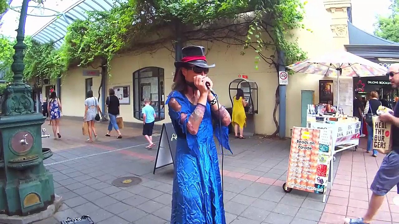 Monty Python harmonica busker in drag
