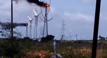 Une éolienne en feu dessine une spirale de fumée