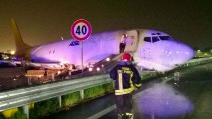 Plane slides off runway through fence in Italy