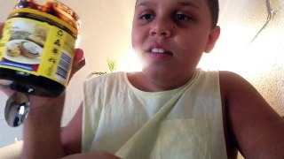 Kid eats a big tablespoon of vegiemite