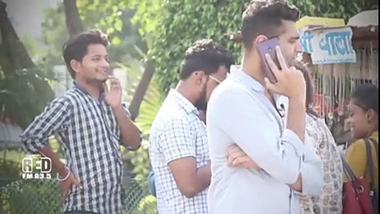 Man shouting on phone among people