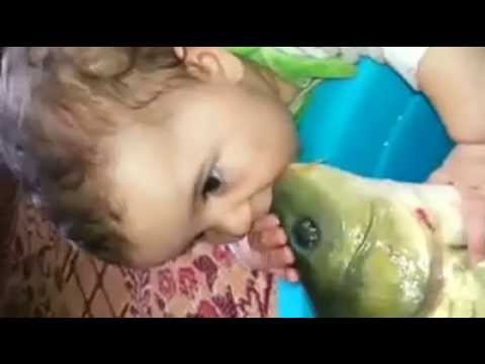 Baby kisses a live fish OMG :O