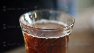 Macro of turkish transparent teacup with hot black tea mix by teaspoon