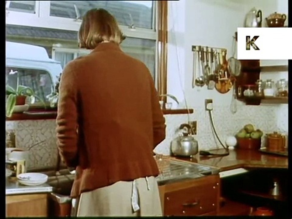 Late 70s woman in kitchen washing up