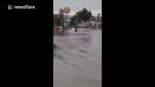 Man takes jet ski out onto flooded street