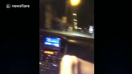 Man uses feet to drive while playing on his smart phone