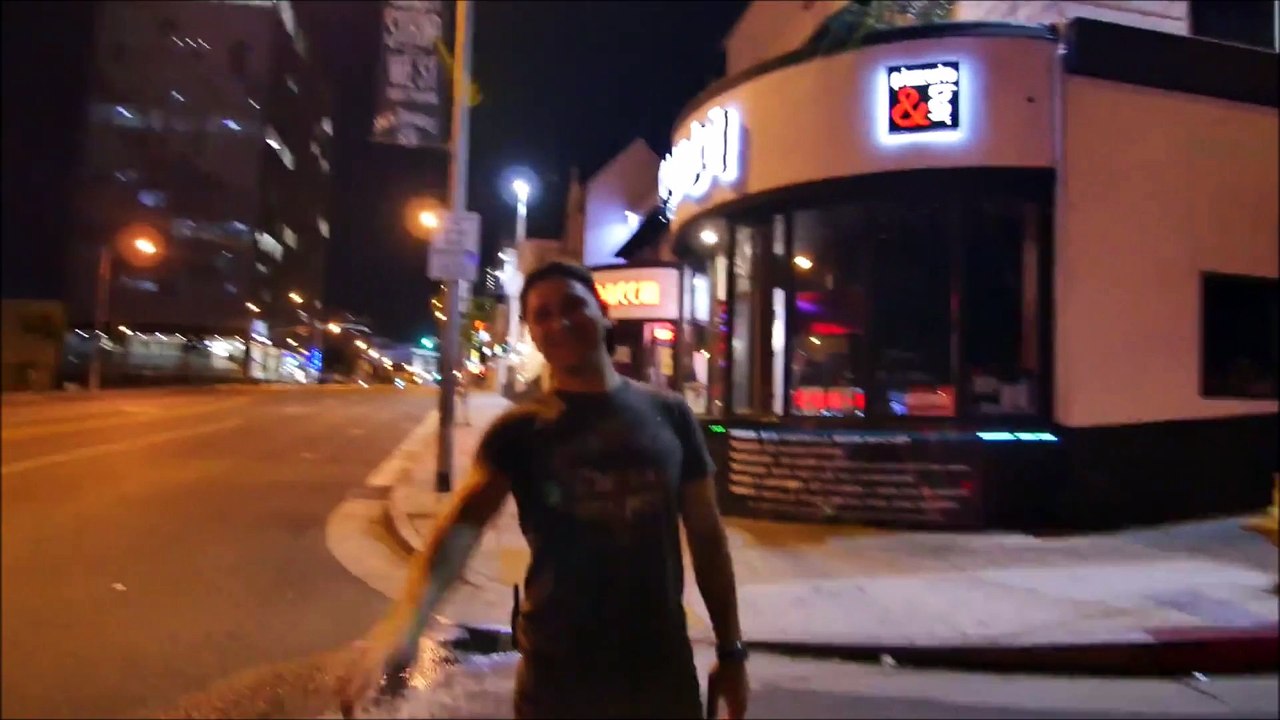 Skaters Glide Down a Deserted Sunset Boulevard