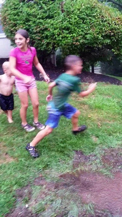 Kids Make Water Slide Out of Grass In Typhoon Like Rain Storm, Play In Puddle & Find A Shower & Clean In Stream