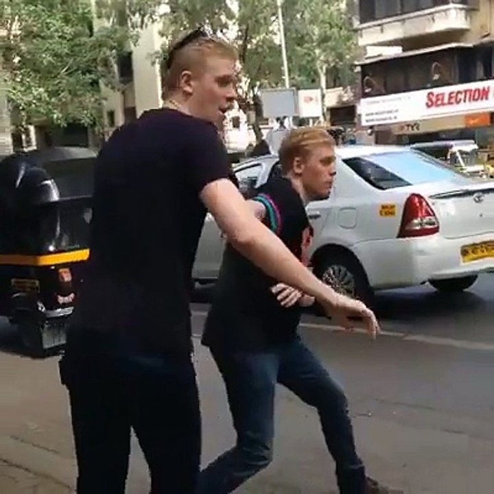 English boys are trying to cross the road in Pakistan