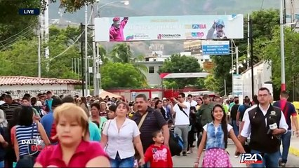 Mass pour into Colombia to buy basic goods as border reopens