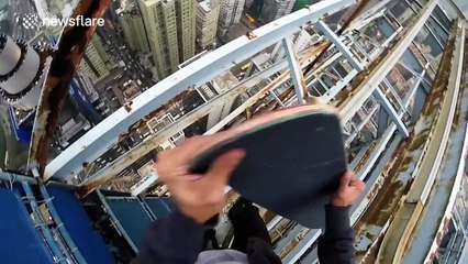Daredevil skateboarder balances on edge of skyscraper in Hong Kong