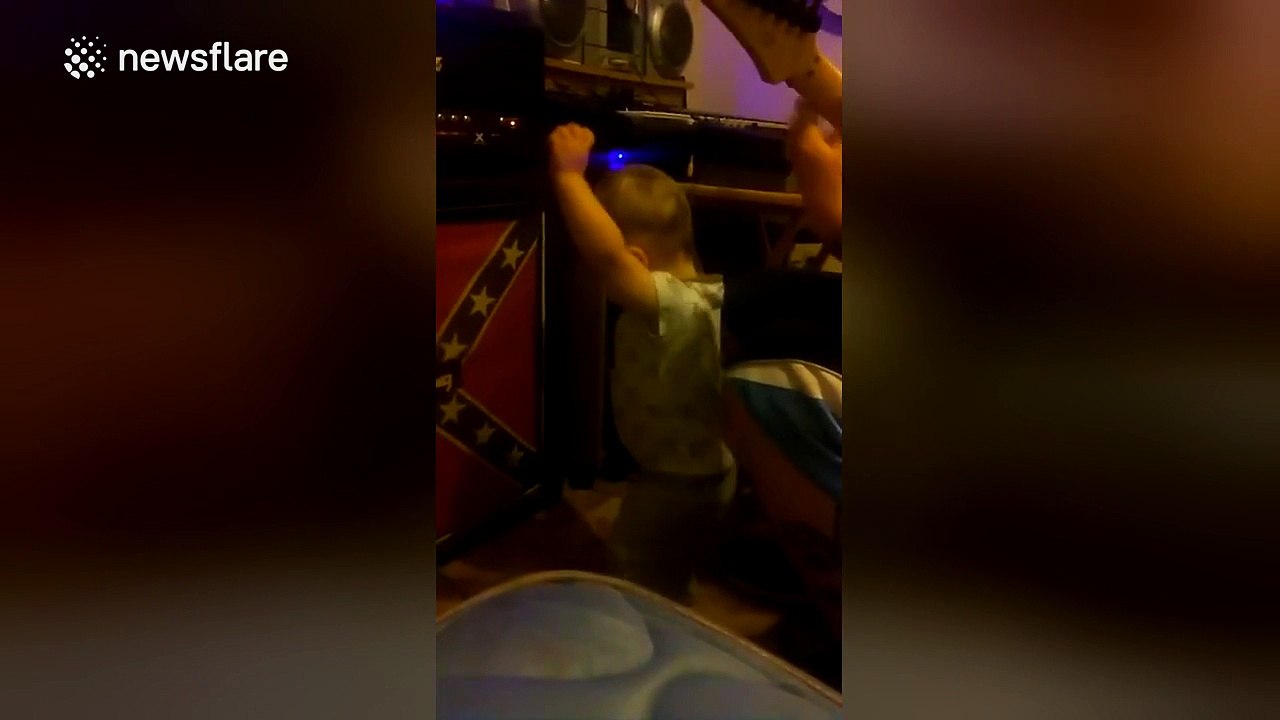 Baby 'rocks out' to heavy metal while dad plays guitar