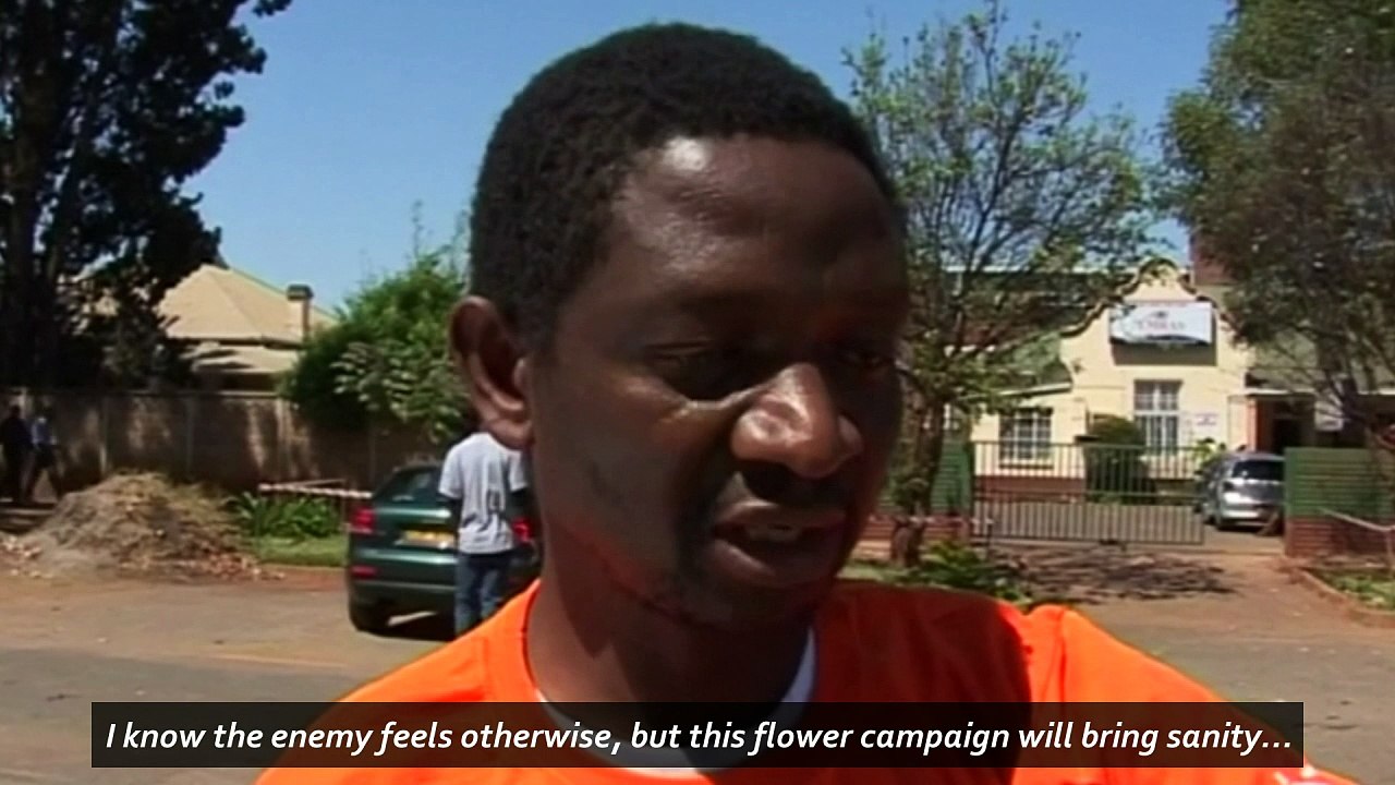 Activist beaten by Zimbabwe police after offering flowers
