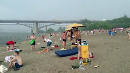 Beach-goers run for cover during freak hail storm in Russia