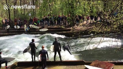 Surfers ride waves on river in Munich
