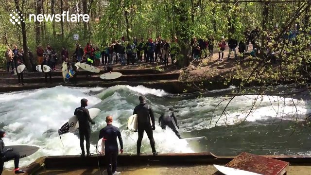Surfers ride waves on river in Munich