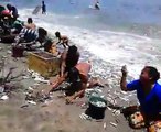 Fishes came out from sea and people full their baskets easily