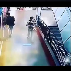 Boy save a girl from falling from stairs in a mall