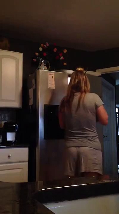 Woman Scared Silly after Opening Refrigerator Door